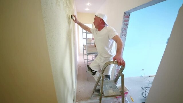 Two professional builders making finish in the apartment.