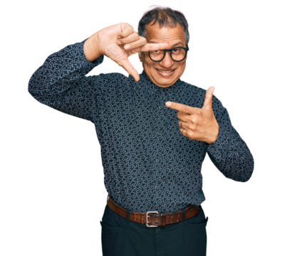 Middle age indian man wearing casual clothes and glasses smiling making frame with hands and fingers with happy face. creativity and photography concept.