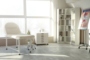 Interior of medical office with couch and shelf unit