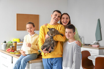 Happy family with cat in kitchen