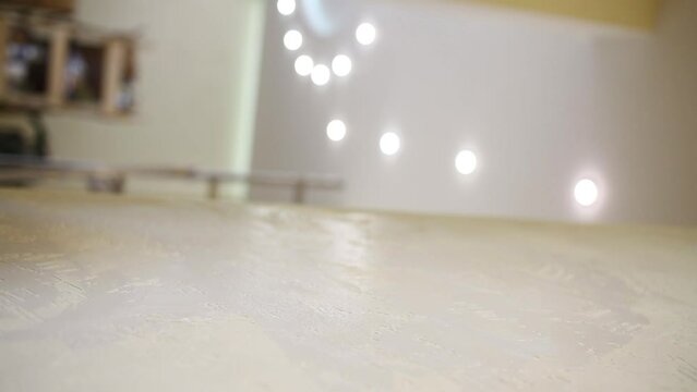 Builder is polishing a wall using the sanding sponge.