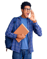 Young african american man wearing student backpack holding book shouting and screaming loud to side with hand on mouth. communication concept.