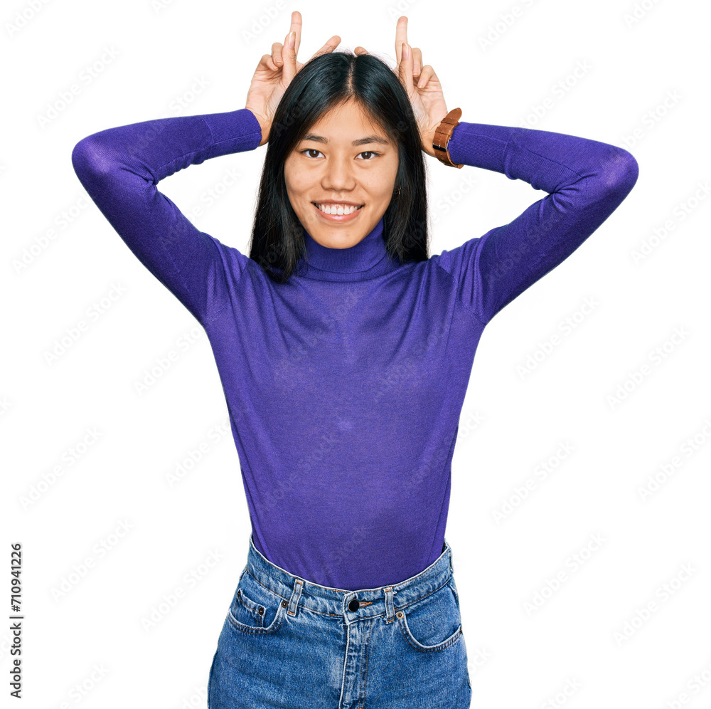 Poster beautiful young asian woman wearing casual clothes posing funny and crazy with fingers on head as bu