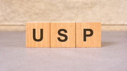USP acronym concept on cubes, gray background, selective focus