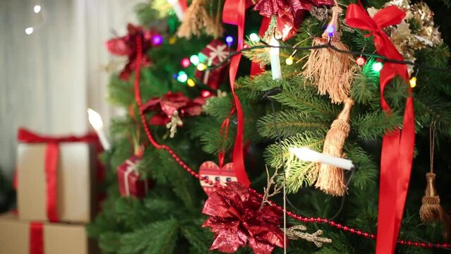 Christmas toys hanging on artificial fur-tree and garland