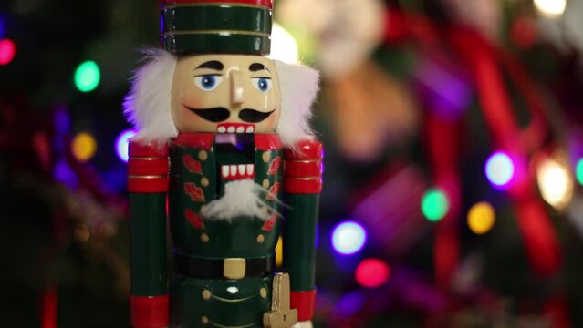 Toy Nutcracker, fir branches with illumination of Christmas tree