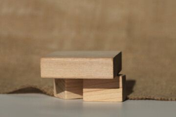 Wooden eco rustic platform podium on gray copy space background. Minimal empty light and shadow display product presentation scene.