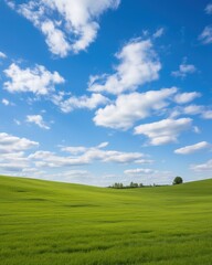 Fototapeta premium Green rolling hills under blue sky and white clouds