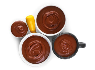 Bowls and cup of tasty melted chocolate on white background