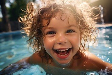 Fototapeta na wymiar Curly Haired Child Having Fun in the Swimming Pool