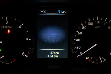 Car dashboard lights showing speed and temperature. Car instrument panel with speedometer and digital temperature.