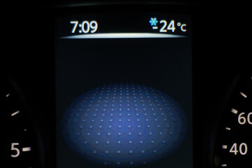 Car dashboard lights showing speed and temperature. Car instrument panel with speedometer and...