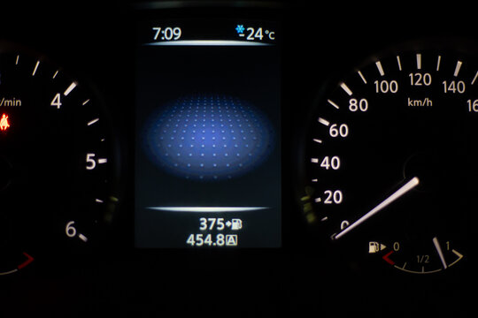 Car dashboard lights showing speed and temperature. Car instrument panel with speedometer and digital temperature.