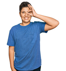 Teenager hispanic boy wearing casual clothes doing ok gesture with hand smiling, eye looking through fingers with happy face.