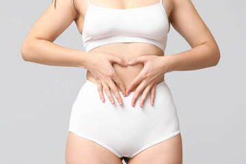 Body positive woman in underwear on light background, closeup