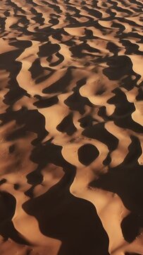 Aerial top view on sand dunes in Sahara desert, Africa. Vertical video