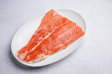 fresh, delicious salmon fillet on a white plate