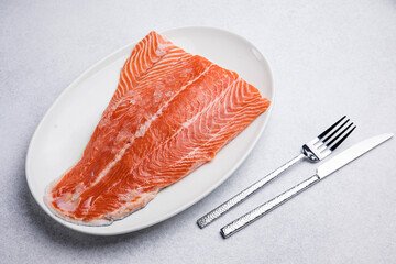 fresh, delicious salmon fillet on a white plate