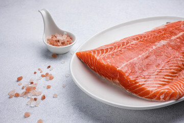 fresh, delicious salmon fillet on a white plate