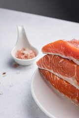 fresh, delicious salmon fillet on a white plate