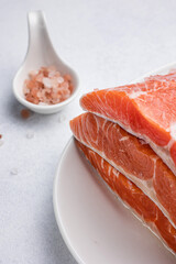 fresh, delicious salmon fillet on a white plate