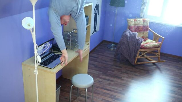 Man in jeans jumps on ceiling upside down at inverted house