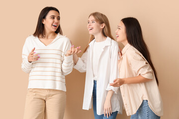 Portrait of beautiful women on beige background