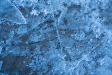 Naklejka premium Icy winter background cracked grunge texture. Natural scratched ice on a skating rink as a texture or background for a winter composition, large long painting