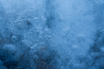 Icy winter background cracked grunge texture. Natural scratched ice on a skating rink as a texture or background for a winter composition, large long painting