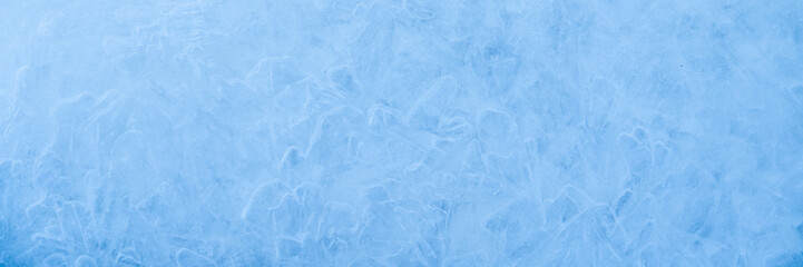 Obraz premium Icy winter background cracked grunge texture. Natural scratched ice on a skating rink as a texture or background for a winter composition, large long painting