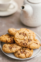 Sweet chocolate cookies on plate on kitchen table.