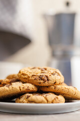 Sweet chocolate cookies on plate on kitchen table.