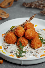 Potato croquettes - mashed potatoes balls breaded and deep fried, served with different sauce.