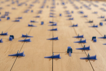 Repair and construction. Laying ceramic tiles using cement on the floor close-up. A man lays slabs on the floor and walls.