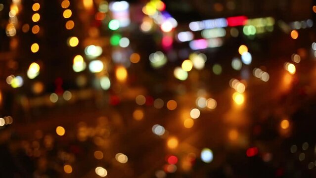 Blurred night view of car traffic and city lights.