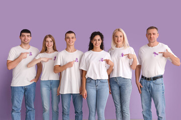 People pointing at lavender awareness ribbons on color background. World Cancer Day