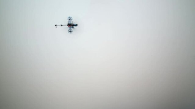 Toy rc helicopter with propellers flies turning 