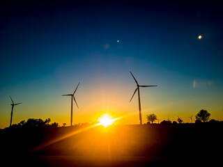 Obraz premium Wind turbines at sunset, alternative energy source. Alternative energy concept