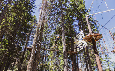 Fearless teenager girl at forest adventure park