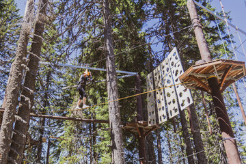 Fearless teenager girl at forest adventure park