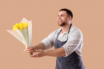 Male florist with tulips on brown background. International Women's Day celebration