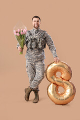 Male soldier with tulips and balloon in shape of figure 8 on brown background. International Women's Day celebration