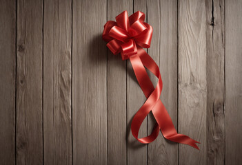 Loosely coiled red ribbon on a wooden backdrop