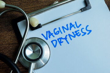 Concept of Vaginal Dryness write on paperwork with stethoscope isolated on wooden background.