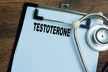 Concept of Testoterone write on paperwork with stethoscope isolated on wooden background.