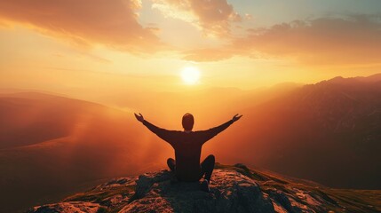 Obraz premium Silhouette of a person kneeling with open arms and looking at the sky on top of a mountain. Concept of religious and spiritual life. Warm atmosphere at dawn. Copy space