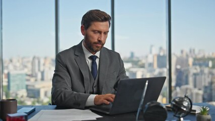 Office man starting day opening laptop lid. Successful entrepreneur working desk
