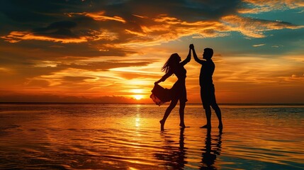 Silhouette of romantic couple dance on the beach at beautiful sunset time