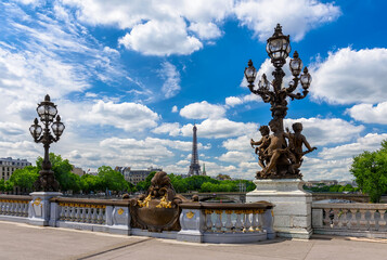 Fototapeta na wymiar Street lantern on the Alexandre III Bridge with the Eiffel Tower in the background in Paris, France. Eiffel Tower is one of the most iconic landmarks of Paris. Cityscape of Paris