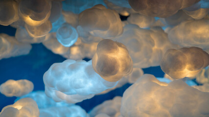 Background of clouds made of white cotton with yellow lighting inside